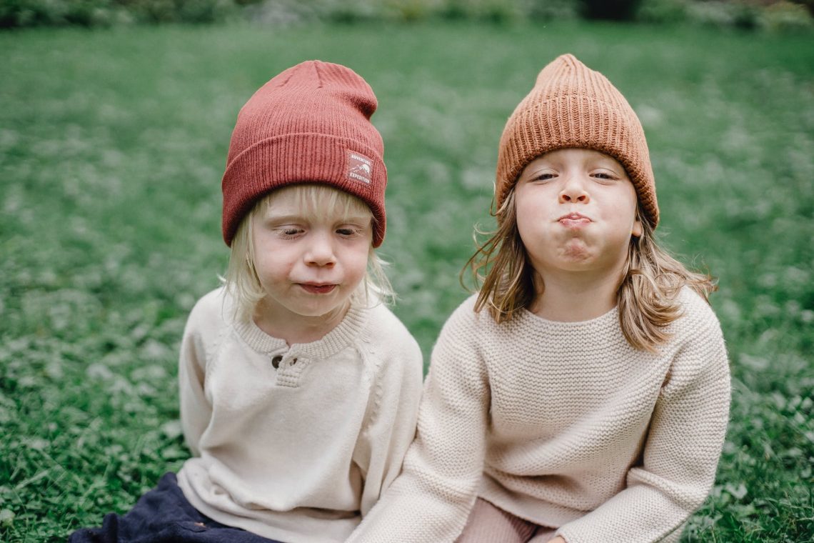 little kids in green yard in sunny day