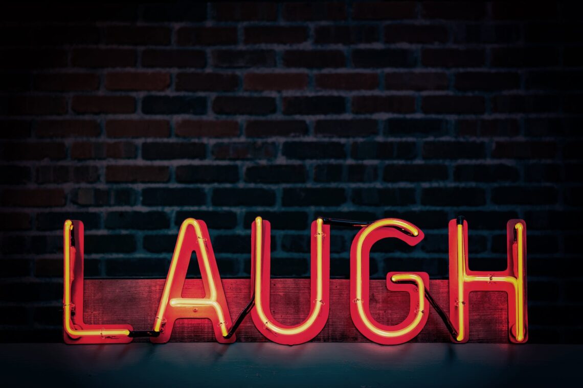 laugh neon light signage turned on