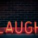 laugh neon light signage turned on